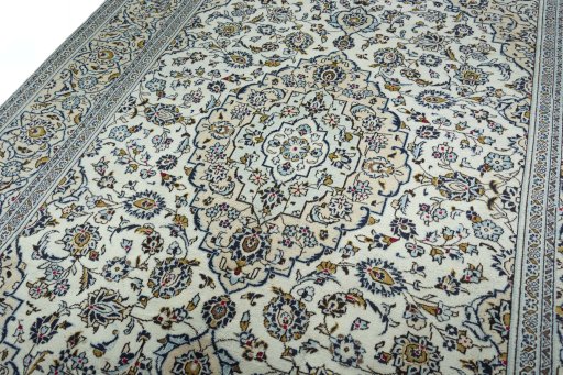 Backside of handmade 2000s Kashan rug showing knot structure and weave density