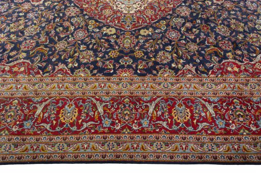 Corner detail of 2000s Kashan rug showing border pattern and Cork pile