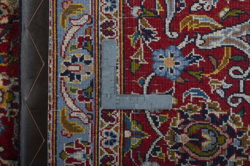 Backside of handmade 2000s Kashan rug showing knot structure and weave density