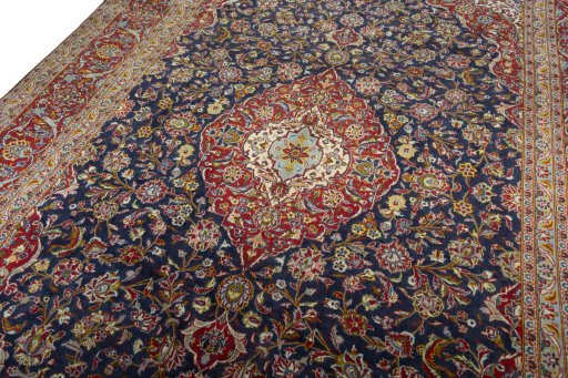 Backside of handmade 2000s Kashan rug showing knot structure and weave density