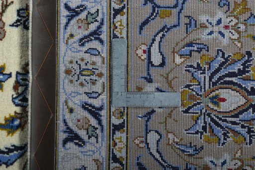 Backside of handmade 2000s Kashan rug showing knot structure and weave density
