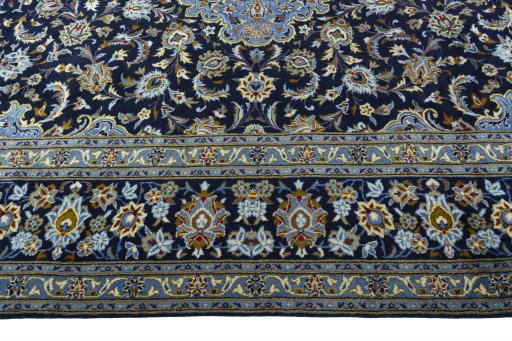 Corner detail of 2000s Kashan rug showing border pattern and Wool pile