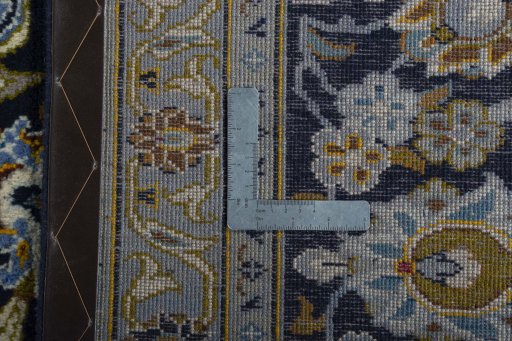 Backside of handmade 2000s Kashan rug showing knot structure and weave density