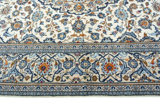 Corner detail of 2000s Kashan rug showing border pattern and Wool pile