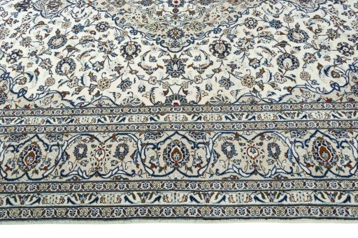 Corner detail of 2000s Kashan rug showing border pattern and Wool pile