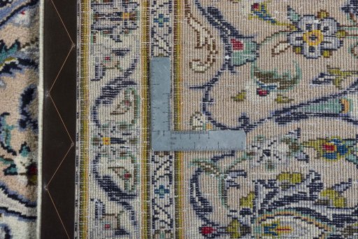 Backside of handmade 2000s Kashan rug showing knot structure and weave density