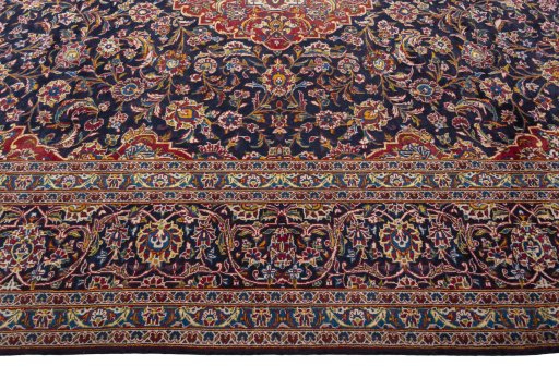 Corner detail of 2000s Kashan rug showing border pattern and Wool pile