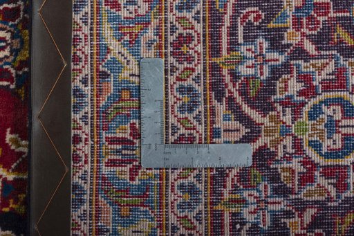 Backside of handmade 2000s Kashan rug showing knot structure and weave density