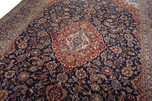 Backside of handmade 2000s Kashan rug showing knot structure and weave density