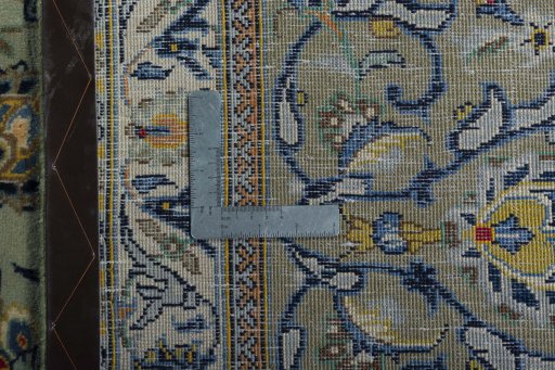 Backside of handmade 2000s Kashan rug showing knot structure and weave density