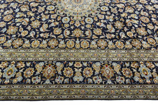 Corner detail of 2000s Kashan rug showing border pattern and Wool pile