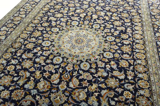 Backside of handmade 2000s Kashan rug showing knot structure and weave density