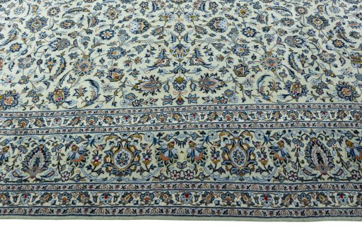 Corner detail of 2000s Kashan rug showing border pattern and Wool pile