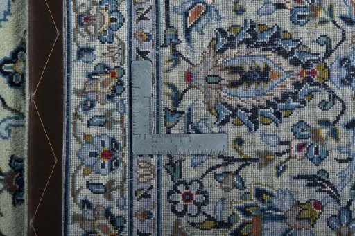 Backside of handmade 2000s Kashan rug showing knot structure and weave density