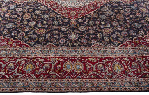 Corner detail of 2000s Kashan rug showing border pattern and Wool pile