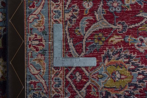 Backside of handmade 2000s Kashan rug showing knot structure and weave density