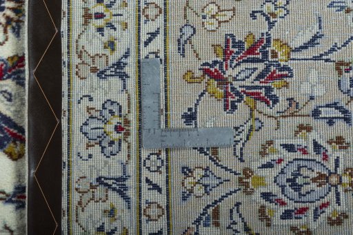 Backside of handmade 2000s Kashan rug showing knot structure and weave density
