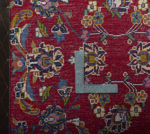 Backside of handmade 2000s Kashan rug showing knot structure and weave density