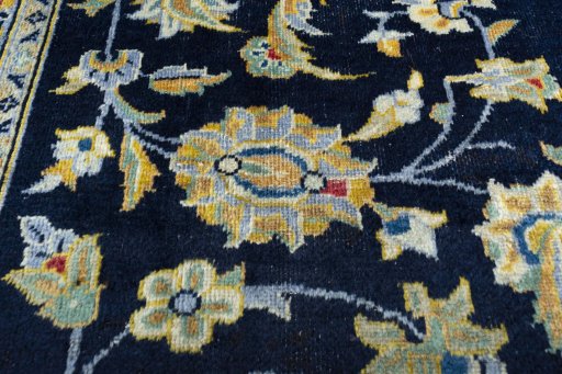 Backside of handmade 1970s Kashan rug showing knot structure and weave density