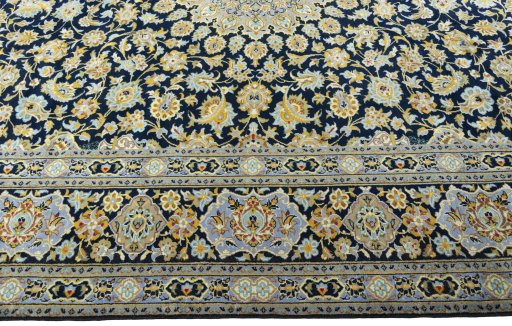 Corner detail of 2000s Kashan rug showing border pattern and Wool pile