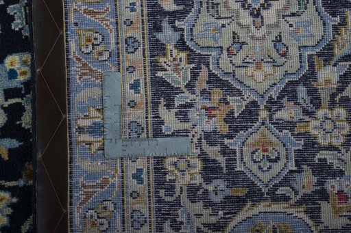 Backside of handmade 2000s Kashan rug showing knot structure and weave density