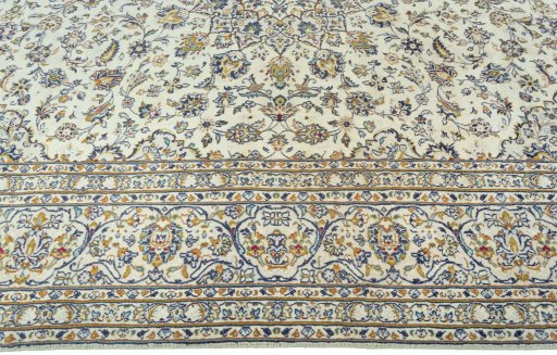 Corner detail of 2000s Kashan rug showing border pattern and Wool pile