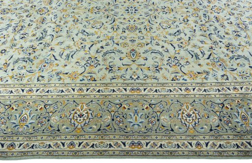 Corner detail of 2000s Kashan rug showing border pattern and Wool pile
