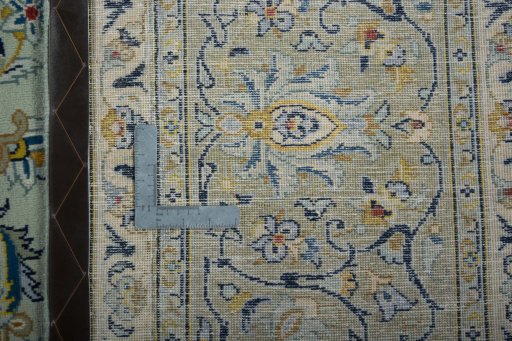 Backside of handmade 2000s Kashan rug showing knot structure and weave density