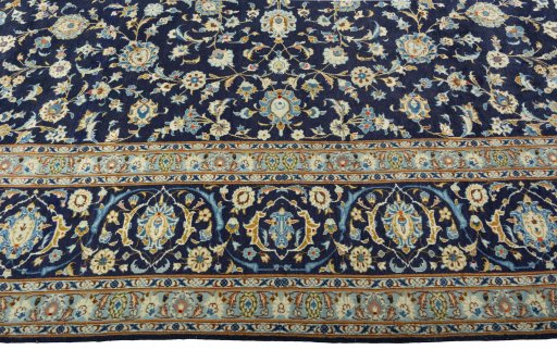 Corner detail of 2000s Kashan rug showing border pattern and Wool pile