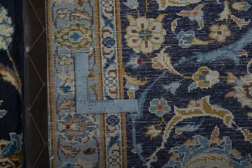 Backside of handmade 2000s Kashan rug showing knot structure and weave density