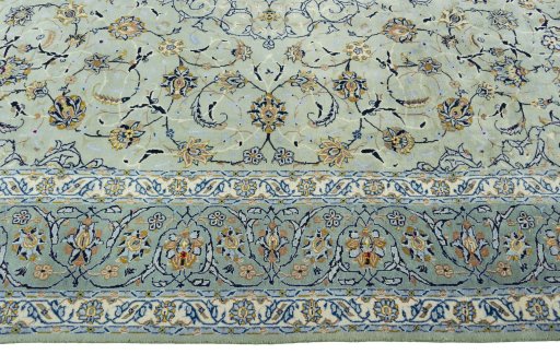 Corner detail of 2000s Kashan rug showing border pattern and Wool pile