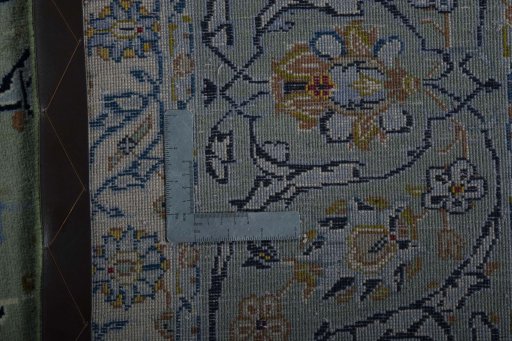 Backside of handmade 2000s Kashan rug showing knot structure and weave density