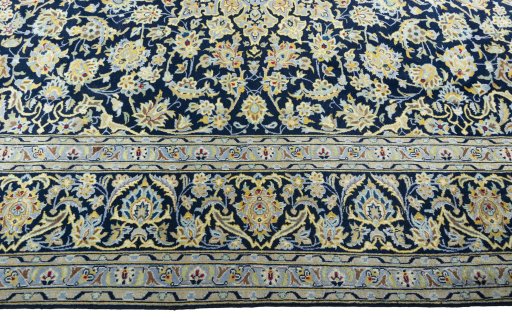 Corner detail of 1970s Kashan rug showing border pattern and Wool pile