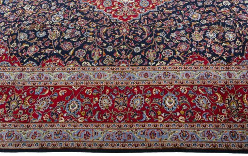 Corner detail of 2000s Kashan rug showing border pattern and Wool pile