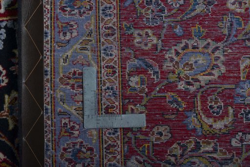Backside of handmade 2000s Kashan rug showing knot structure and weave density