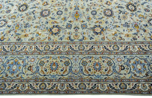 Corner detail of 2000s Kashan rug showing border pattern and Wool pile
