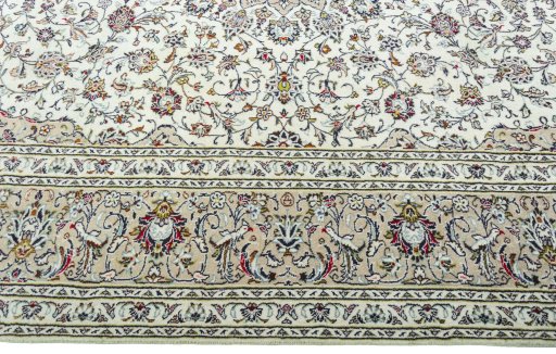 Corner detail of 2000s Kashan rug showing border pattern and Wool pile