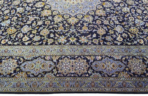 Corner detail of 2000s Kashan rug showing border pattern and Cork pile