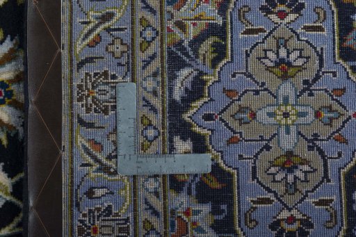 Backside of handmade 2000s Kashan rug showing knot structure and weave density