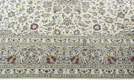 Corner detail of 2000s Kashan rug showing border pattern and Wool pile