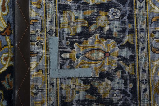 Backside of handmade 1970s Kashan rug showing knot structure and weave density
