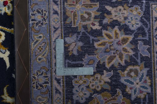 Backside of handmade 2000s Kashan rug showing knot structure and weave density
