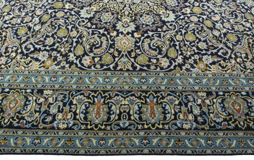Corner detail of 2000s Kashan rug showing border pattern and Wool pile