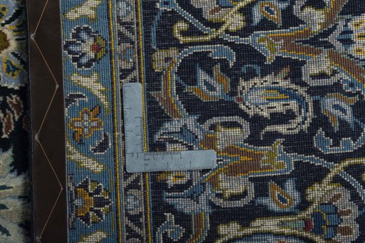 Backside of handmade 2000s Kashan rug showing knot structure and weave density