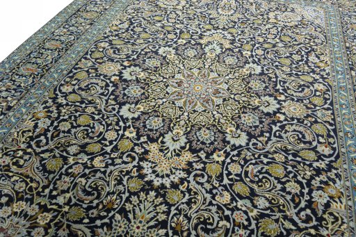 Backside of handmade 2000s Kashan rug showing knot structure and weave density