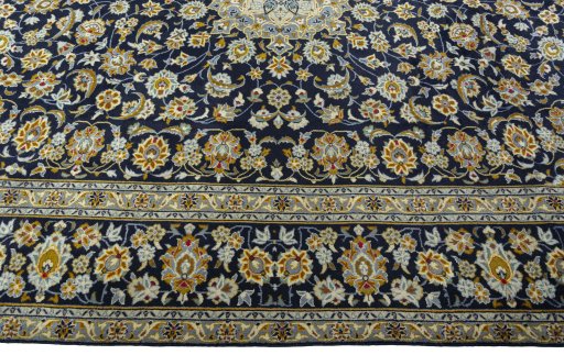 Corner detail of 2000s Kashan rug showing border pattern and Wool pile