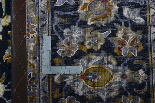 Backside of handmade 2000s Kashan rug showing knot structure and weave density