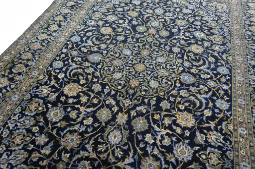 Backside of handmade 2000s Kashan rug showing knot structure and weave density