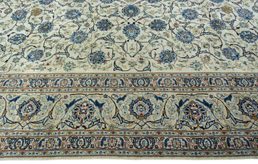 Corner detail of 2000s Kashan rug showing border pattern and Wool pile