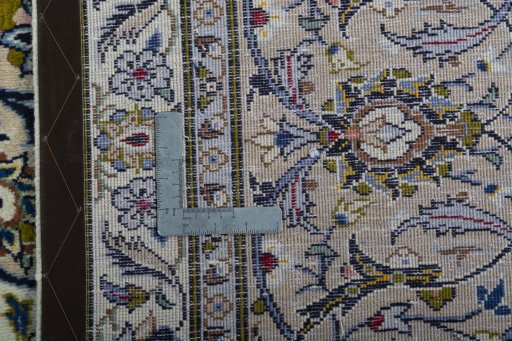 Backside of handmade 2000s Kashan rug showing knot structure and weave density